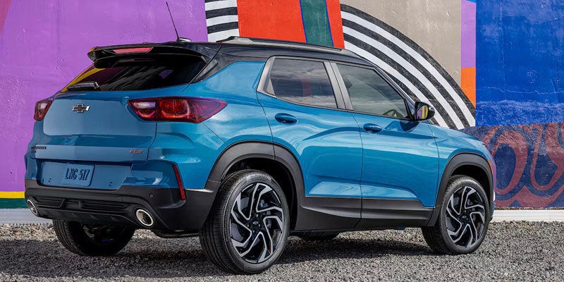 2025 Chevrolet Trailblazer angled, rearview in front of a funky mural